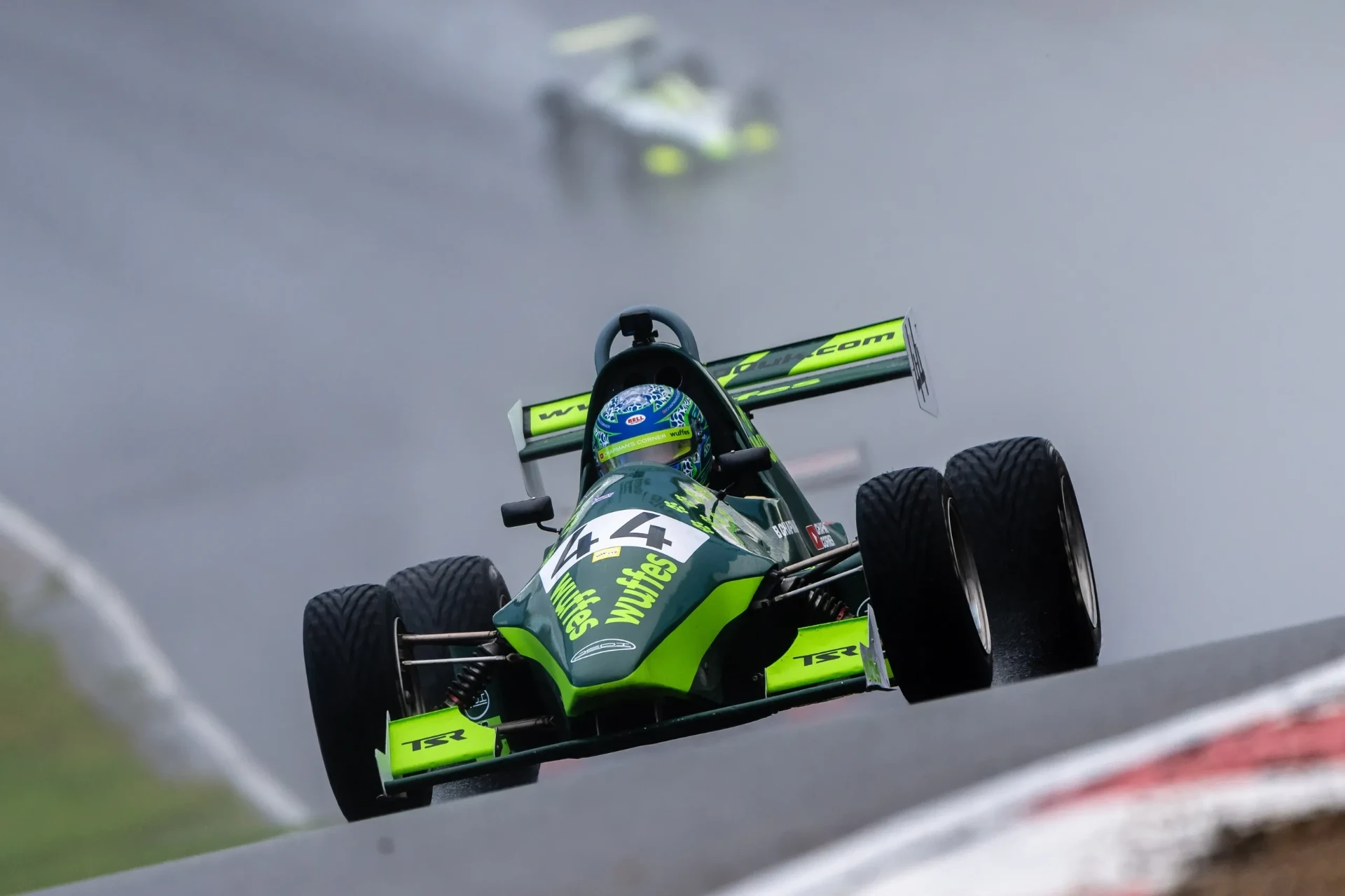 Bert Chapman’s number 44 race car racing through the spray