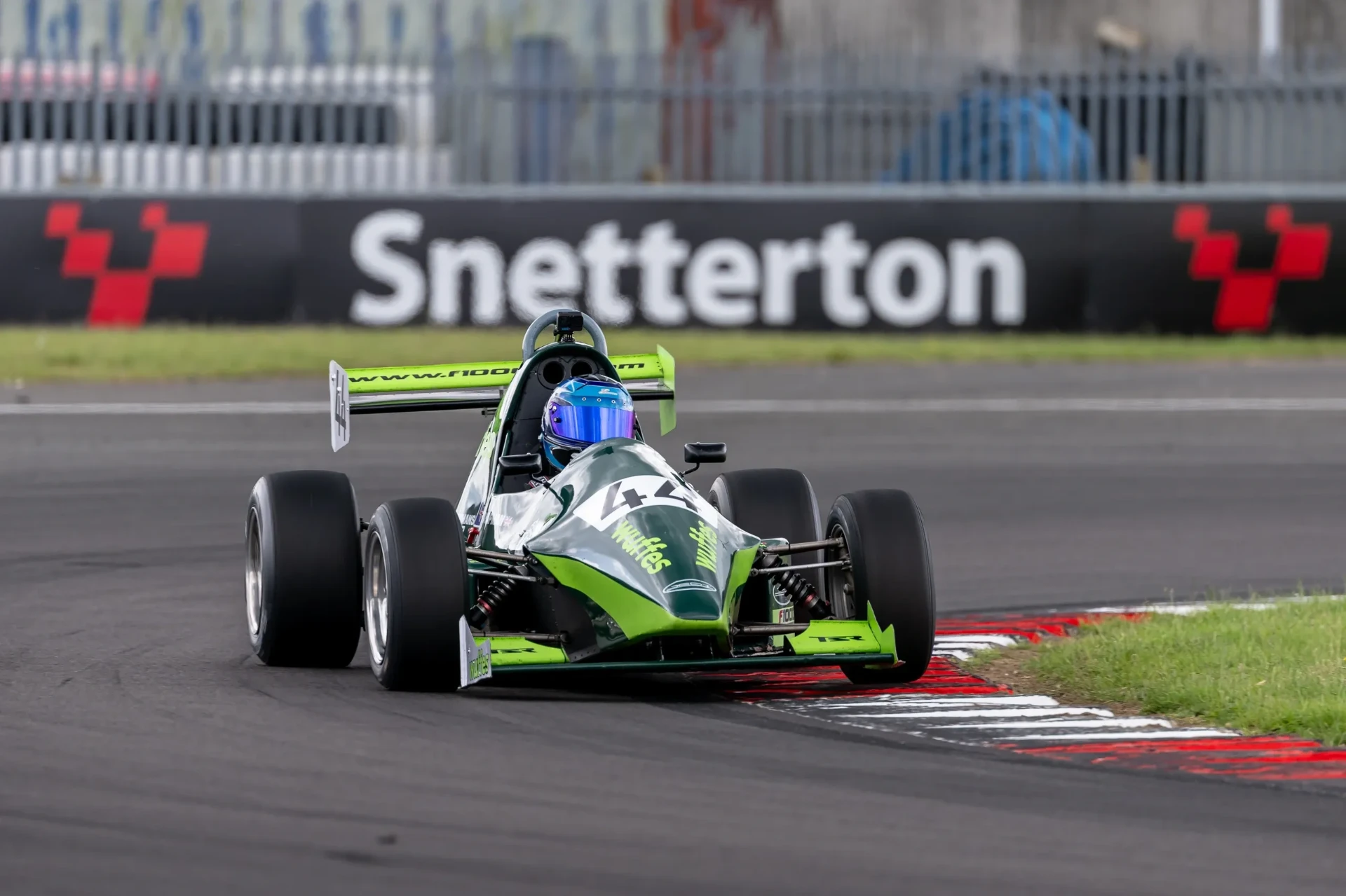 The number 44 car taking a kerb at Snetterton