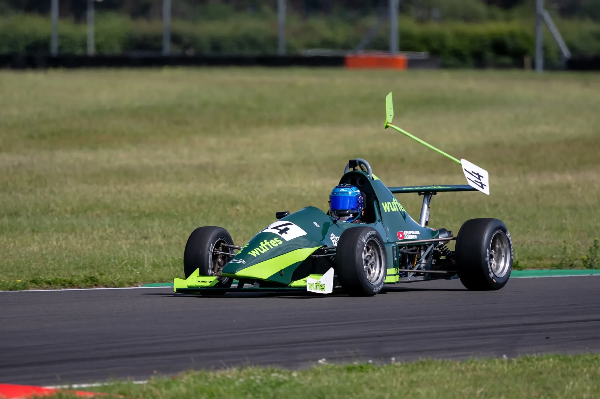 Bert’s green race car on track with damage to the rear wing